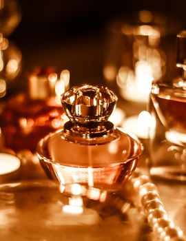 Perfumery, cosmetics branding and luxe concept - Perfume bottle and vintage fragrance on glamour vanity table at night, pearls jewellery and eau de parfum as holiday gift, luxury beauty brand present