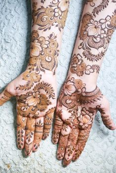 women applying henna on hand .