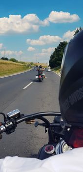 Snapshoot while riding a motorcycle on the road, blue sky. High quality photo