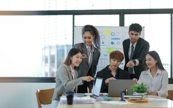 Young happy Asian business man, woman work together, celebrate success in start up office. Creative team brainstorm meeting, businesspeople colleague partnership or office coworker teamwork concept.