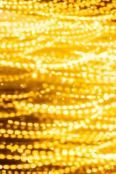 Golden Christmas lights, New Years Eve fireworks and abstract texture concept - Glamorous gold shiny glow and glitter, luxury holiday background