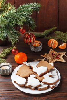 Delicious homemade Christmas cookies in the form of a rabbit and a Christmas tree on a wooden table decorated with New Year's decor. Copy spase