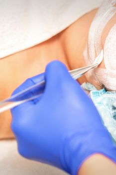 Face peeling at the beautician. Facial treatment. The beautician applies a cleansing face mask to the female patient