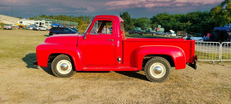 Red american farm car with nature background. High quality photo