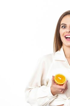 Joyful attractive young woman having piece of orange isolated on white background with copy space