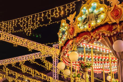 Illuminated swing chain carousel in amusement park at night.