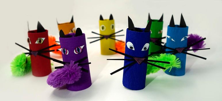 Paper cats made out of toilet rolls in the colors of the rainbow