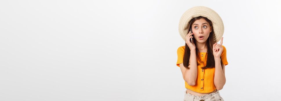 Picture of surprised voyage girl looking shock while holding phone in hands isolated over grey background.