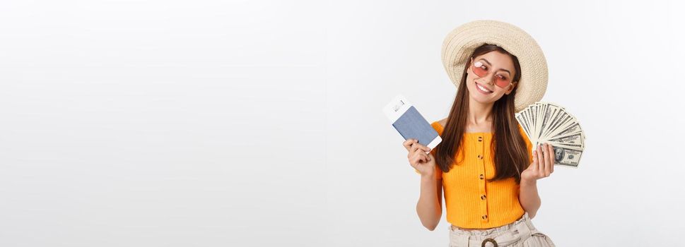 Portrait of cheerful, happy, laughing girl with hat on head, having money fan and passport with tickets in hands, isolated on white background.