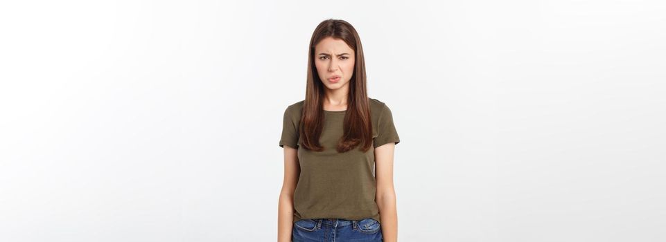 Close-up portrait of a young attractive woman who covers her nose, something stinks, isolated on white background.