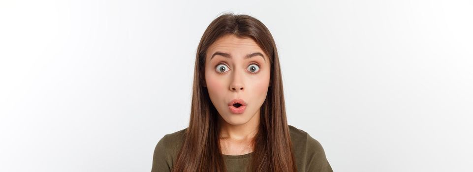 Close-up portrait of surprised beautiful girl holding her head in amazement and open-mouthed. Over white background.