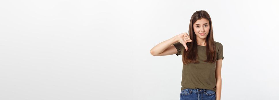 Image of resentful woman with long dark hair showing thumbs down isolated over gray background