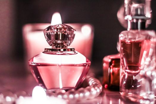 Perfumery, cosmetics branding and luxe concept - Perfume bottle and vintage fragrance on glamour vanity table at night, pearls jewellery and eau de parfum as holiday gift, luxury beauty brand present