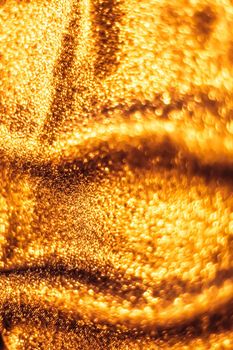 Luxe glowing texture, night club branding and New Years party concept - Golden holiday sparkling glitter abstract background, luxury shiny fabric material for glamour design and festive invitation
