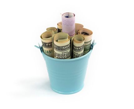 banknotes in a bucket. Dollars and Euros in little decorative blue. Concept full of money. High quality photo