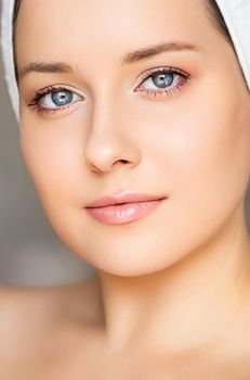 Skin care and beauty routine, beautiful woman with white towel wrapped around head, skincare cosmetics and face cosmetology, close-up portrait