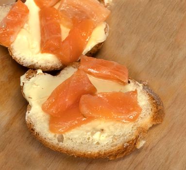 sandwich with salmon slices. white bread with butter and fish. gluten and butter. French baguette. snack. High quality photo