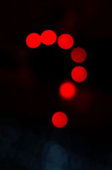 Question mark make with red light in abstract background. Neon light night discussion.