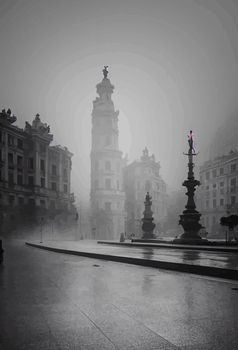 view of madrid street with the Plaza de Cibeles in the background in a foggy day.