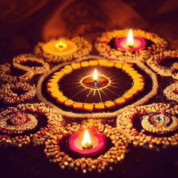 illustration of the Oil lamps lit in the colorful rangoli during the celebration of diwali