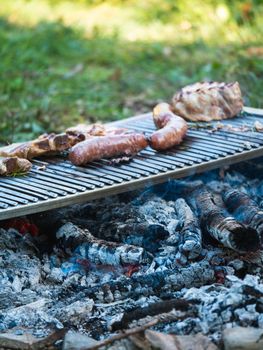 cooking pork meat in the grill outdoors with charcoal