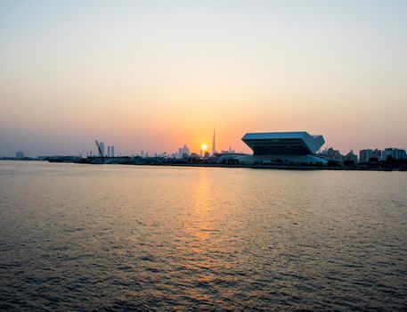 Sunset at Dubai Festival city. New building of Sheikh Muhammad Bin Rashid library on the scene as well as tallest building in the world Burj Khalifa on background. Outdoors