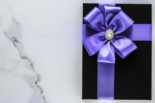 Wedding present, shop sale promotion and anniversary celebration concept - Luxury holiday gifts with lavender silk ribbon and bow on marble background