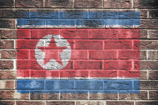 A North Korea flag on old brick wall background