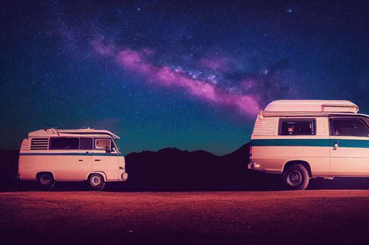 Elevated view of a campervan lit up under a night sky.