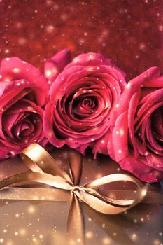 Celebration, holiday season and love concept - Valentines day present, luxury gift box and bouquet of roses with shiny snow