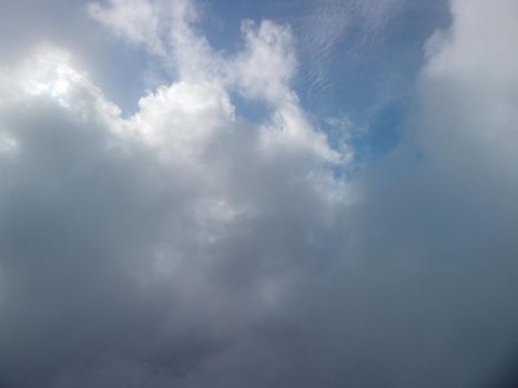 Aerial view drone flying above white clouds dense fog move quickly. Drone flies high back in blue sky through fluffy clouds. Beautiful foggy and cloudy slow moving Aerial view. Fog sea.