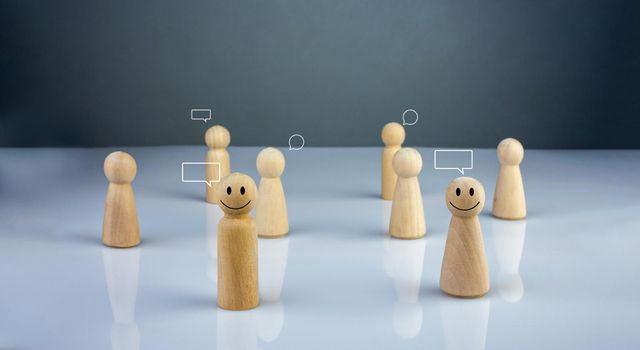 Wooden doll figure with communication and technology symbols. Social media and technology concept.