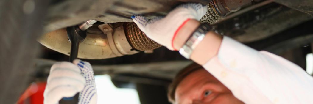 Auto mechanic repairs car suspension. Car workshop services concept