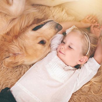 I love you too tiny human. An adorable little girl with her dog at home