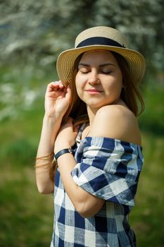 beautiful girl in a dress walking in the spring forest where the trees bloom