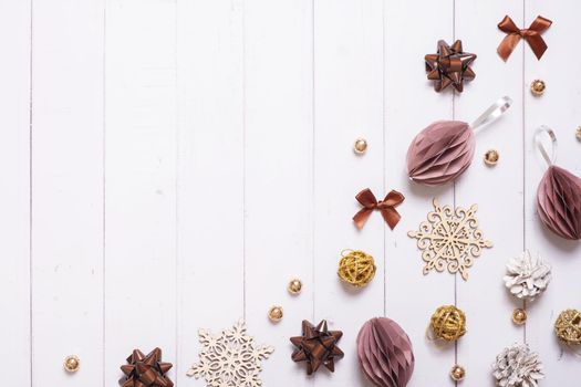 Festive creative christmas composition with paper Christmas balls and other eco friendly decor flat lay on wooden background.