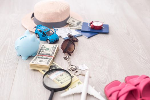 dollars, piggy bank, alarm clock, hat, glasses. Time to go on holiday. Things for summer trip