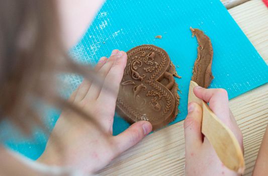 Children make homemade gingerbread cookies. High quality photo