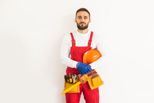 Man builder in a robe, overalls on a white background. Isolate, copy space.