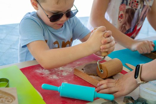 Children make homemade gingerbread cookies. High quality photo