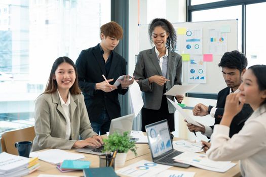 Group of young businessman talking with young and mature colleagues in boardroom at meeting. brainstorming, discussing analyzing business strategy concept