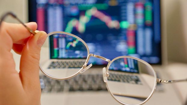 Laptop buy bitcoin on the Binance crypto exchange during the market crash in glasses. Trading, spot, staking. Workspace freelance flatlay