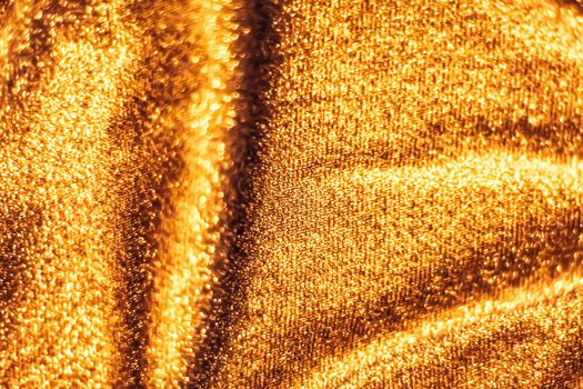 Luxe glowing texture, night club branding and New Years party concept - Golden holiday sparkling glitter abstract background, luxury shiny fabric material for glamour design and festive invitation