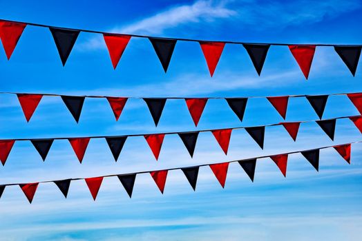 Flying pennons on blue sky background.