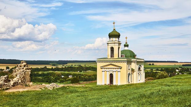 a building used for public Christian worship. Wonderful church and archeological site in a green field on a warm sunny day.