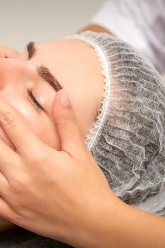 Face massage of detox therapy for the pretty female patient at spa salon