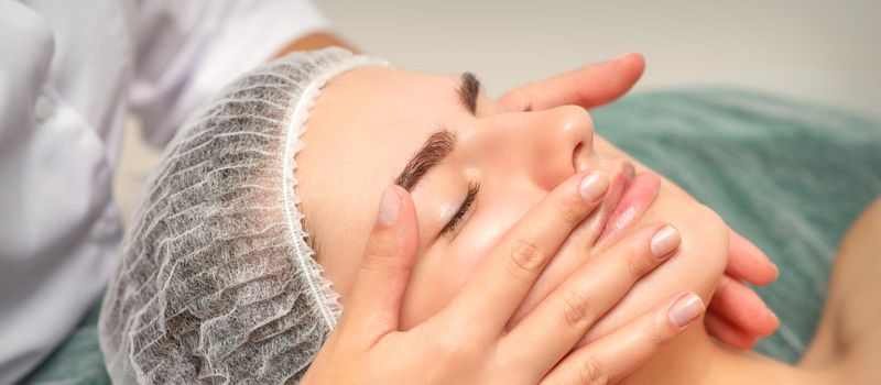 Face massage of detox therapy for the pretty female patient at spa salon