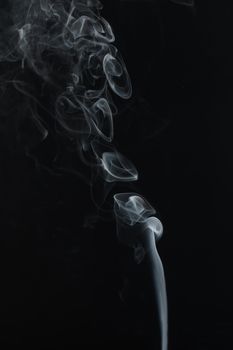 Abstract Smoke swirls on black background