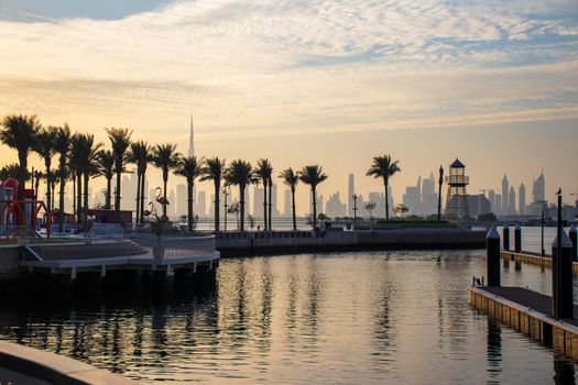 View of a Dubai city skyline from the wharf on Dubai creek harbour. UAE.