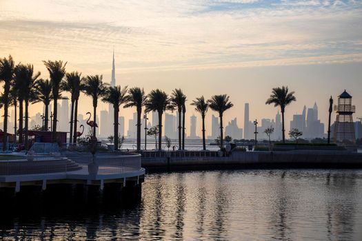 View of a Dubai city skyline from the wharf on Dubai creek harbour. UAE.
